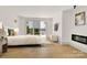Spacious main bedroom with a fireplace, lake views, and light hardwood floors throughout at 124 Clipper Ln, Mooresville, NC 28117