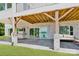Covered patio with stone pillars, a stainless steel grill, and comfortable seating overlooking the lake at 124 Clipper Ln, Mooresville, NC 28117