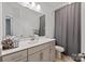 A well-lit bathroom features a large mirror, modern fixtures, and neutral tones creating a clean and inviting space at 1260 Thomas Knapp Pkwy, Fort Mill, SC 29715