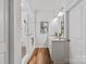 Bright white bathroom with a glass shower enclosure, double vanity, and wood look floors at 1260 Thomas Knapp Pkwy, Fort Mill, SC 29715