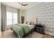 Comfortable bedroom with a tufted headboard, patterned wallpaper, and a ceiling fan at 1260 Thomas Knapp Pkwy, Fort Mill, SC 29715