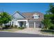 Charming home with a blue exterior, a two-car garage, a covered porch, and well-maintained landscaping at 1260 Thomas Knapp Pkwy, Fort Mill, SC 29715