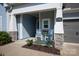 Inviting front porch with rocking chairs, stone accents, and a well-manicured garden at 1260 Thomas Knapp Pkwy, Fort Mill, SC 29715
