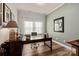 Well-lit home office with a large desk, neutral paint, and natural light from the window at 1260 Thomas Knapp Pkwy, Fort Mill, SC 29715