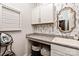 Functional laundry room with a sink, storage cabinets, granite countertops, and decorative wallpaper at 1260 Thomas Knapp Pkwy, Fort Mill, SC 29715