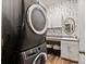 Modern laundry room with stacked washer/dryer, countertop space, and storage cabinets at 1260 Thomas Knapp Pkwy, Fort Mill, SC 29715