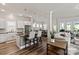 Open-concept living area with a kitchen island, dining area, and comfortable living space at 1260 Thomas Knapp Pkwy, Fort Mill, SC 29715