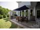 Backyard with outdoor dining area featuring a large table, built-in grill, and stylish patio furnishings at 1260 Thomas Knapp Pkwy, Fort Mill, SC 29715