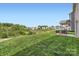 Expansive backyard featuring a lush green lawn, patio furniture, and a fence and tree line at 128 Championship Dr, Mooresville, NC 28115
