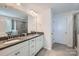 Bathroom featuring double sinks with granite counters and a glass-enclosed shower at 128 Championship Dr, Mooresville, NC 28115