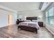 Primary bedroom features tray ceiling, wood-look floors and natural light at 128 Championship Dr, Mooresville, NC 28115