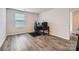 Bedroom featuring wood-look flooring, an off-white wall, and a window allowing for plenty of natural light at 128 Championship Dr, Mooresville, NC 28115
