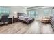 Primary bedroom features tray ceiling, wood-look floors and natural light at 128 Championship Dr, Mooresville, NC 28115