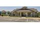 Clubhouse with accessible parking, an entry gate and outdoor seating, surrounded by lush greenery at 128 Championship Dr, Mooresville, NC 28115