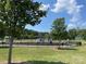 Community park with playground equipment, open grassy area, and a seating bench at 128 Championship Dr, Mooresville, NC 28115