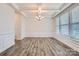 Dining area featuring wood floors, decorative chandelier, large windows, and detailed wall trim at 128 Championship Dr, Mooresville, NC 28115