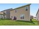 Exterior view of the home showcasing its siding, windows, and patio area in the backyard at 128 Championship Dr, Mooresville, NC 28115