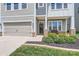 Welcoming home entrance features stone accents, a dark door, and beautiful landscaping at 128 Championship Dr, Mooresville, NC 28115