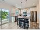 Bright kitchen with white cabinets, stainless steel appliances, and a granite island at 128 Championship Dr, Mooresville, NC 28115