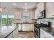 Bright kitchen featuring granite countertops, stainless steel appliances, and a view to the backyard at 128 Championship Dr, Mooresville, NC 28115