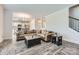 Spacious living room featuring wood floors, a cozy couch, and seamless flow to modern kitchen at 128 Championship Dr, Mooresville, NC 28115