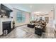 Open concept living room with fireplace, wood floors, and seamless flow to the modern kitchen at 128 Championship Dr, Mooresville, NC 28115