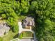 Aerial shot of a traditional style home with a lush green lawn surrounded by beautiful mature trees, driveway, and landscaping at 130 Churchill Dr, Salisbury, NC 28144