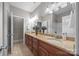 Bright bathroom featuring double sinks, granite countertops, and a large framed mirror at 130 Churchill Dr, Salisbury, NC 28144