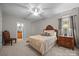 A nicely decorated bedroom with a large bed, an ornate headboard, and natural light from a window at 130 Churchill Dr, Salisbury, NC 28144