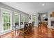 Light-filled dining room featuring hardwood floors, large windows, and access to the backyard at 130 Churchill Dr, Salisbury, NC 28144