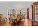 Formal dining room with hardwood floors, chandelier, and large window with red drapes at 130 Churchill Dr, Salisbury, NC 28144