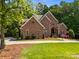 Handsome brick home with a circular drive, neat landscaping, and a welcoming front entrance at 130 Churchill Dr, Salisbury, NC 28144