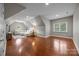 An open living area featuring hardwood floors, a round window, and a comfortable sectional sofa at 130 Churchill Dr, Salisbury, NC 28144