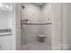 Shower showcasing tile walls and shower seat with glass enclosure at 130 Churchill Dr, Salisbury, NC 28144