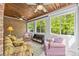 Bright sunroom featuring a brick wall, wood ceiling, and multiple windows for natural light and outdoor views at 130 Churchill Dr, Salisbury, NC 28144