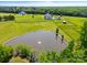 Aerial view of a home with a barn, pond, paddocks, and pool at 1351 Highway 324 None, Rock Hill, SC 29730
