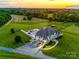Expansive aerial view of estate featuring pool, outdoor living, long driveway, and surrounding pastures at 1351 Highway 324 None, Rock Hill, SC 29730