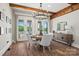 Bright dining area with wood beams, a modern chandelier, and views of the landscaped backyard at 1351 Highway 324 None, Rock Hill, SC 29730