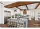 The gourmet kitchen features a large island, seating, modern appliances, and a wood beam ceiling at 1351 Highway 324 None, Rock Hill, SC 29730