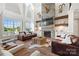 A spacious living room is filled with natural light and features a stone fireplace and wood beams at 1351 Highway 324 None, Rock Hill, SC 29730