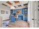 Stylish home office featuring custom blue built-ins, a wood ceiling, and ample natural light at 1351 Highway 324 None, Rock Hill, SC 29730