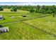 Aerial view of horse paddocks with shelters, surrounded by lush green fields at 1351 Highway 324 None, Rock Hill, SC 29730