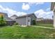 Well-maintained backyard features lush green grass and a charming detached garage at 13714 Jacks Ln, Pineville, NC 28134