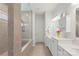 Bathroom featuring a shower with a glass door, double sinks, and lots of cabinet space at 13714 Jacks Ln, Pineville, NC 28134