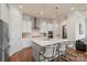 Spacious kitchen features stainless steel appliances, large kitchen island with seating, and hardwood floors at 13714 Jacks Ln, Pineville, NC 28134