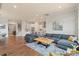Open-concept living room flows into a modern kitchen with hardwood floors and lots of natural light at 13714 Jacks Ln, Pineville, NC 28134