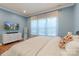 A primary bedroom with blue walls, hard wood floors, and a large bed at 13714 Jacks Ln, Pineville, NC 28134
