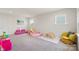 Spacious playroom with lots of natural light, toys, soft carpet and cozy furniture at 13714 Jacks Ln, Pineville, NC 28134