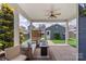 Relaxing covered patio with ceiling fan, comfortable seating, and a charming fire pit at 13714 Jacks Ln, Pineville, NC 28134