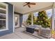 Inviting covered porch boasts comfortable seating, a stylish fire pit, and ample natural light at 13714 Jacks Ln, Pineville, NC 28134
